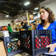 Young woman volunteering to organize donations in large food bank